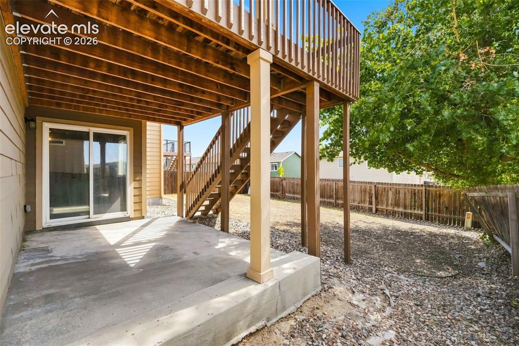 Image 27 of 31: Concrete patio with direct access to a sliding glass door
