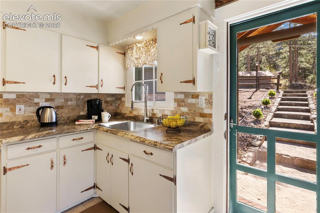 Image 17 of 38: And a surprising amount of room in the kitchen with just the right touch of