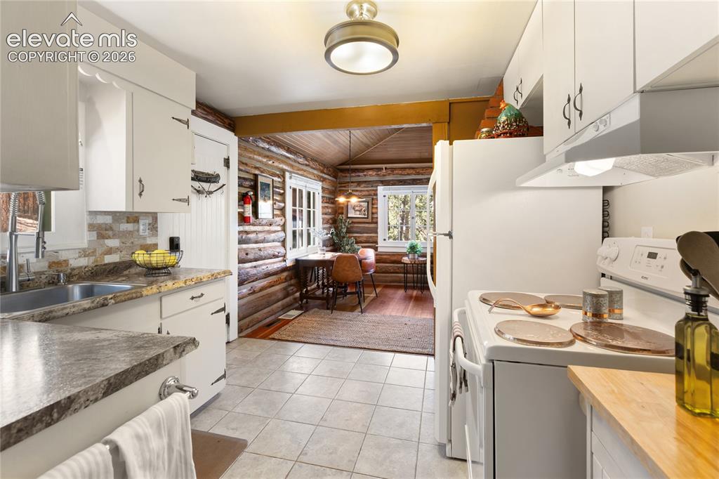 Image 19 of 38: Great location off the living room, with the bathroom just behind the kitch