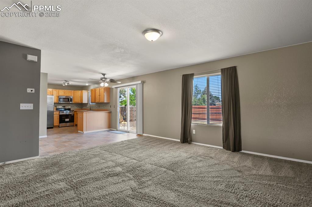 Image 11 of 35: Family Room looking toward dining area and patio doors