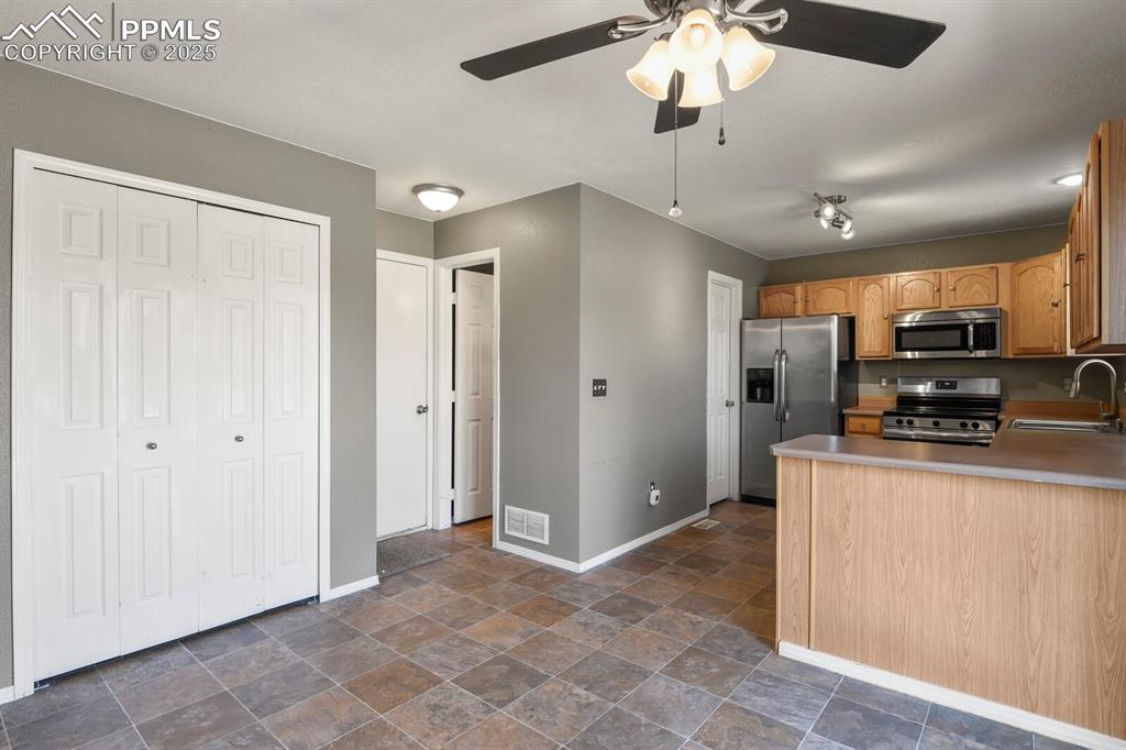 Image 13 of 35: Kitchen with stainless steel appliances.