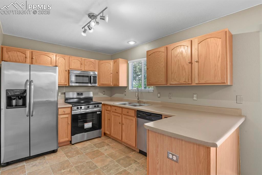 Image 16 of 35: Kitchen with stainless steel appliances