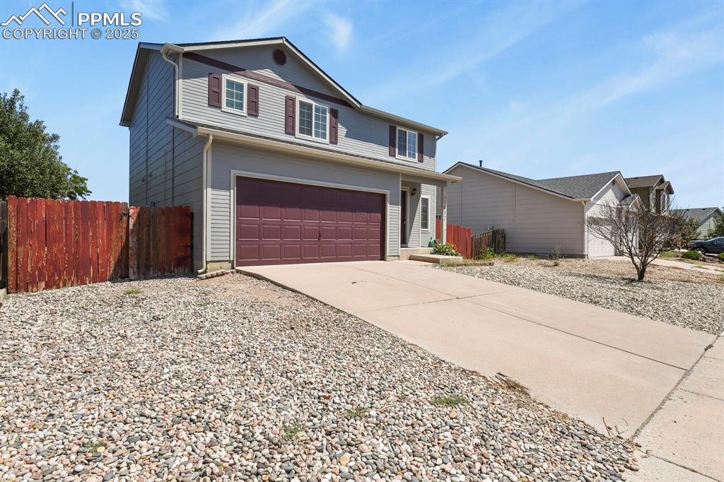 Image 2 of 35: Traditional home featuring concrete driveway and a garage
