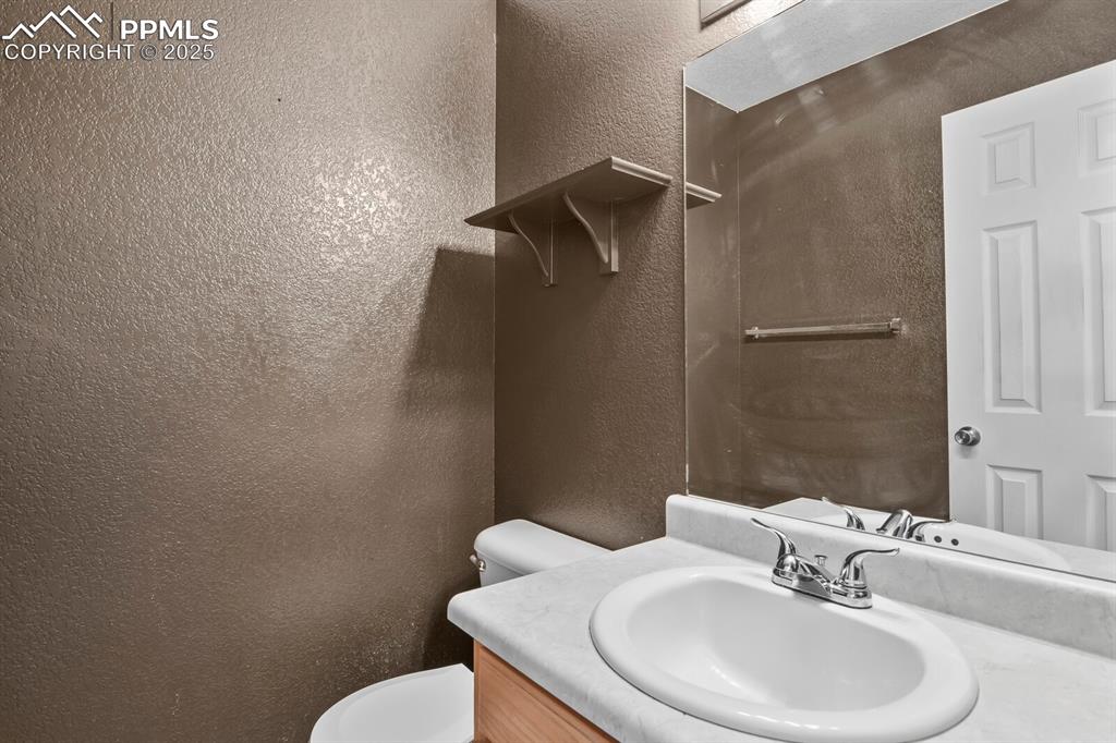 Image 20 of 35: Half bathroom with a vanity on main level