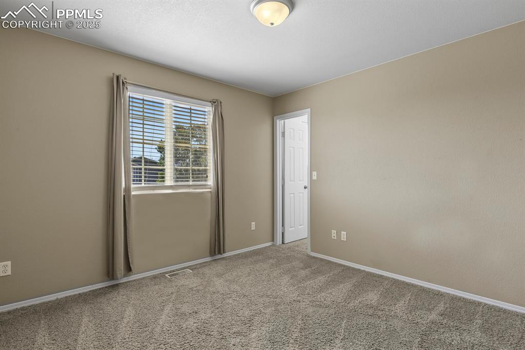 Image 29 of 35: Carpeted spare room with baseboards