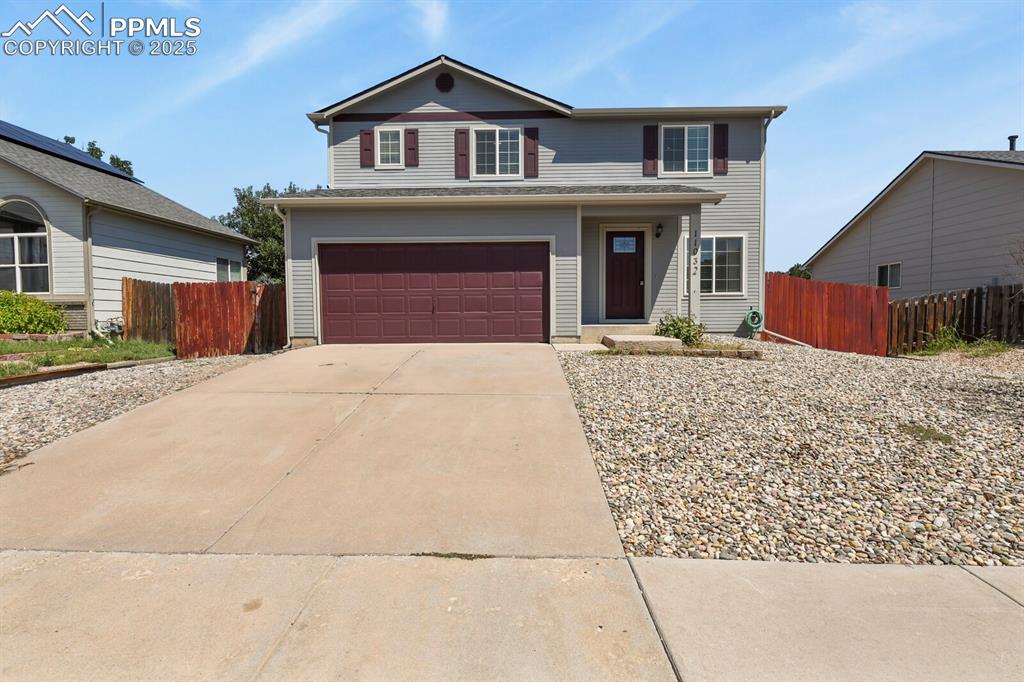 Image 3 of 35: Traditional-style home with a garage and driveway