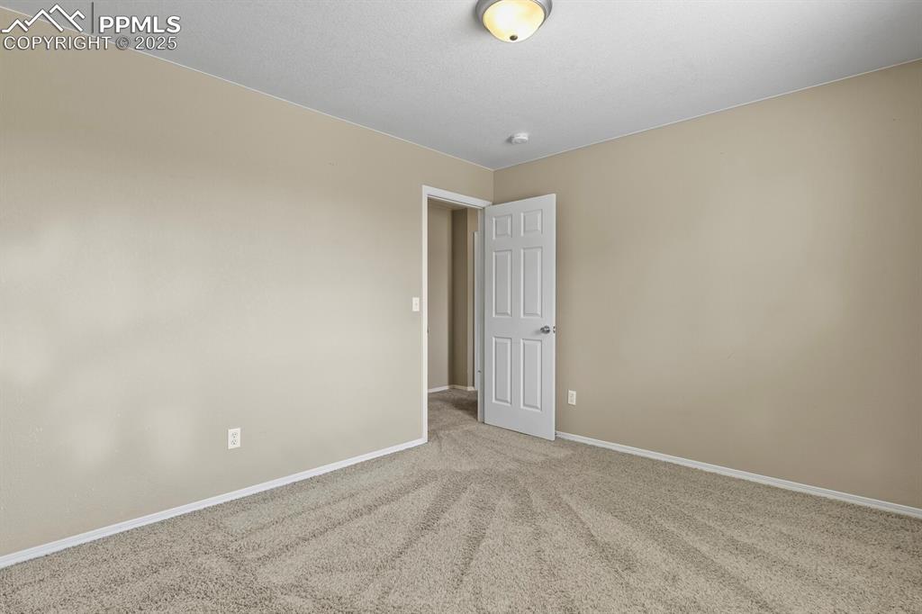 Image 30 of 35: Carpeted empty room featuring baseboards
