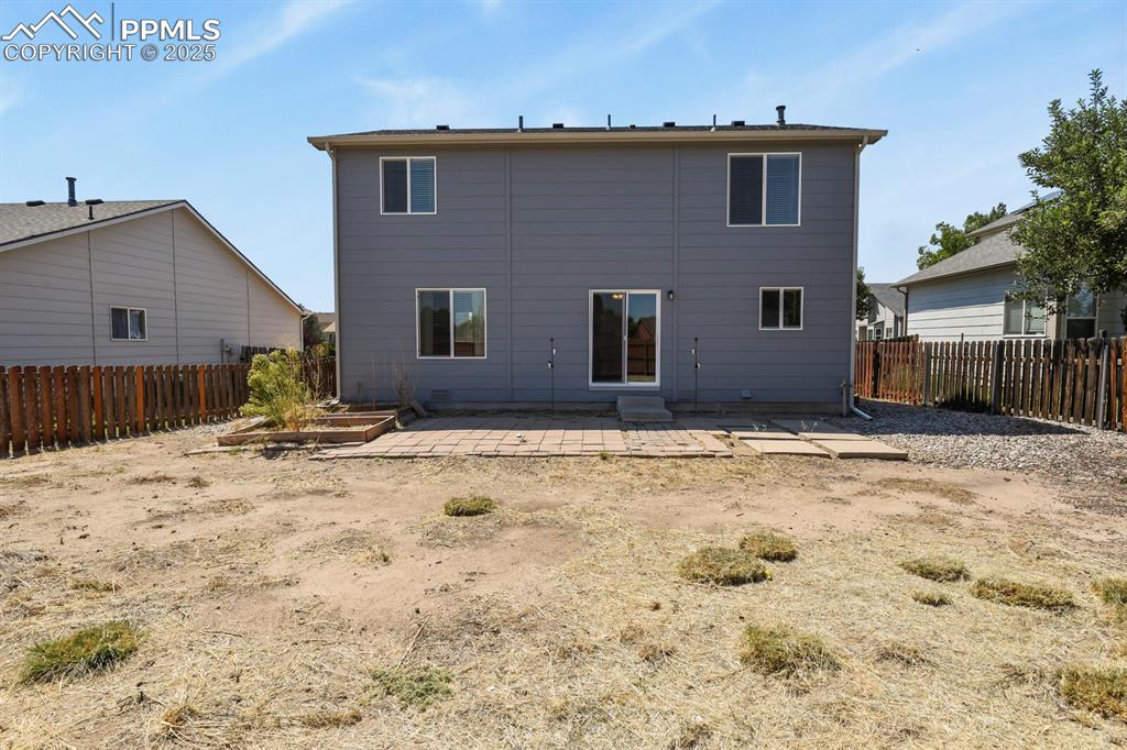 Image 35 of 35: Back of property featuring a patio and fenced back yard
