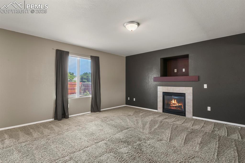 Image 8 of 35: Family room looking toward gas fireplace