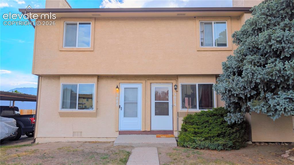 Image 1 of 24: Two-story exterior with a stucco finish and contrasting trim