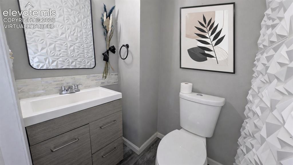 Image 12 of 24: Contemporary bathroom featuring a vanity with a white integrated sink, chro