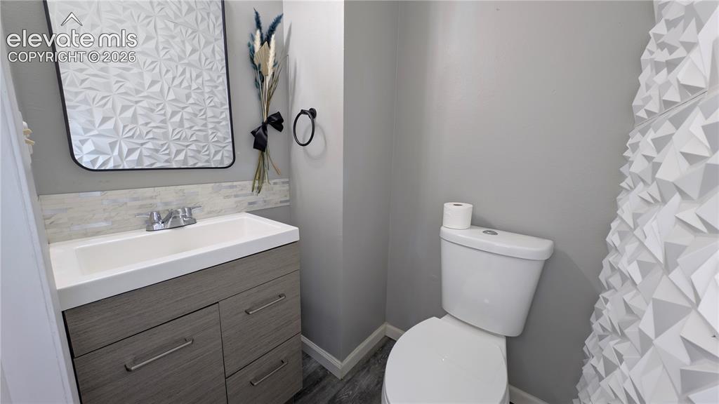 Image 13 of 24: Bathroom featuring a modern vanity with integrated sink, wood-finish cabine