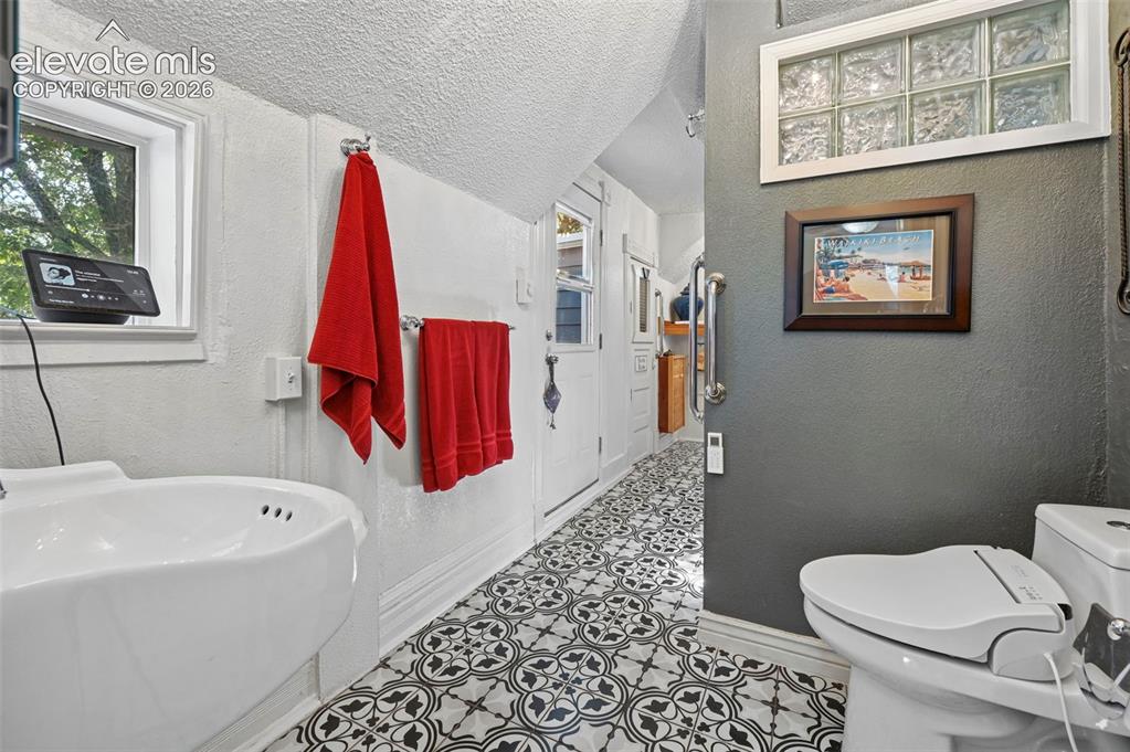 Image 23 of 50: Primary Bath with Tile floors and walk out balcony