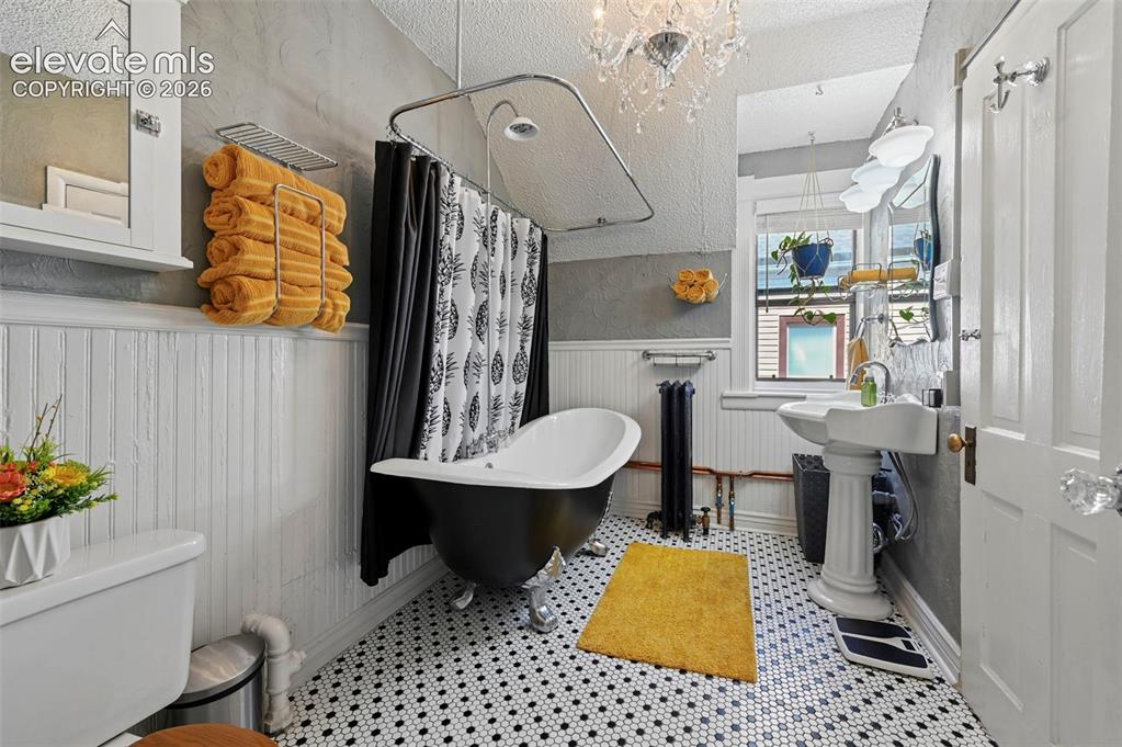 Image 30 of 50: Full Bath with tile floors and Cast Iron Double Slipper Lions Claw tub/show