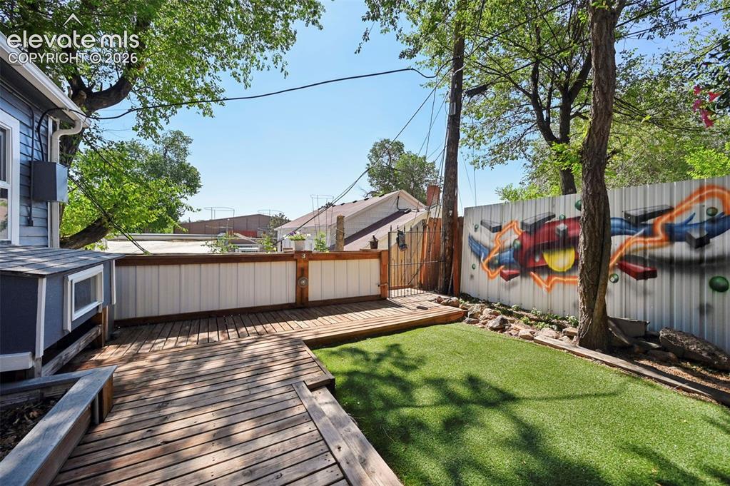 Image 46 of 50: Boardwalk pathways to Raised Garden Bed and Flower Garden