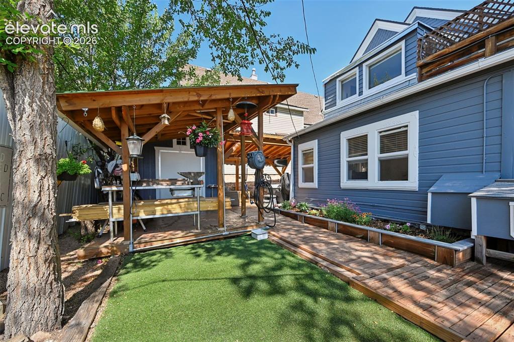 Image 47 of 50: Backyard Shop with Covered Area