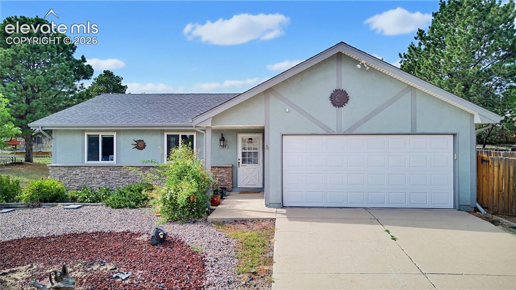 Caption: Single-story residence featuring a gray asphalt shingle roof, light-colored stucco exterior, and sto