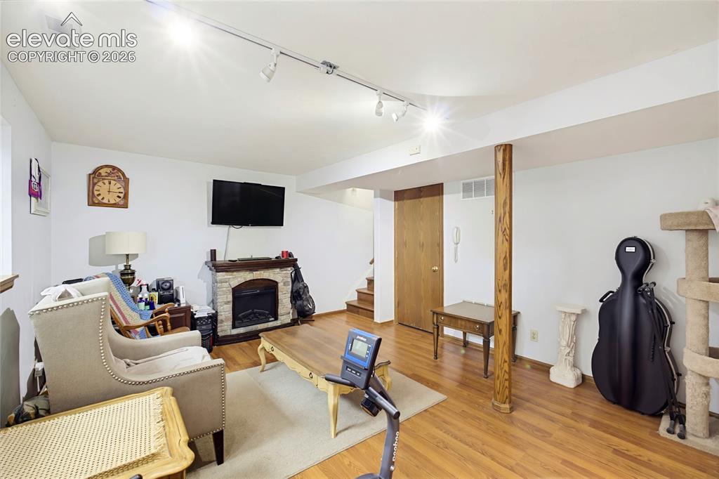 Image 19 of 32: Wood-finish flooring throughout, complemented by recessed lighting and a st