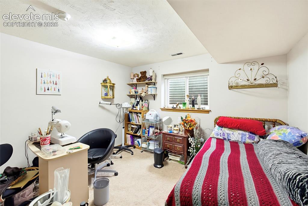 Image 21 of 32: Recessed window with wood trim, carpeted flooring, and built-in shelving