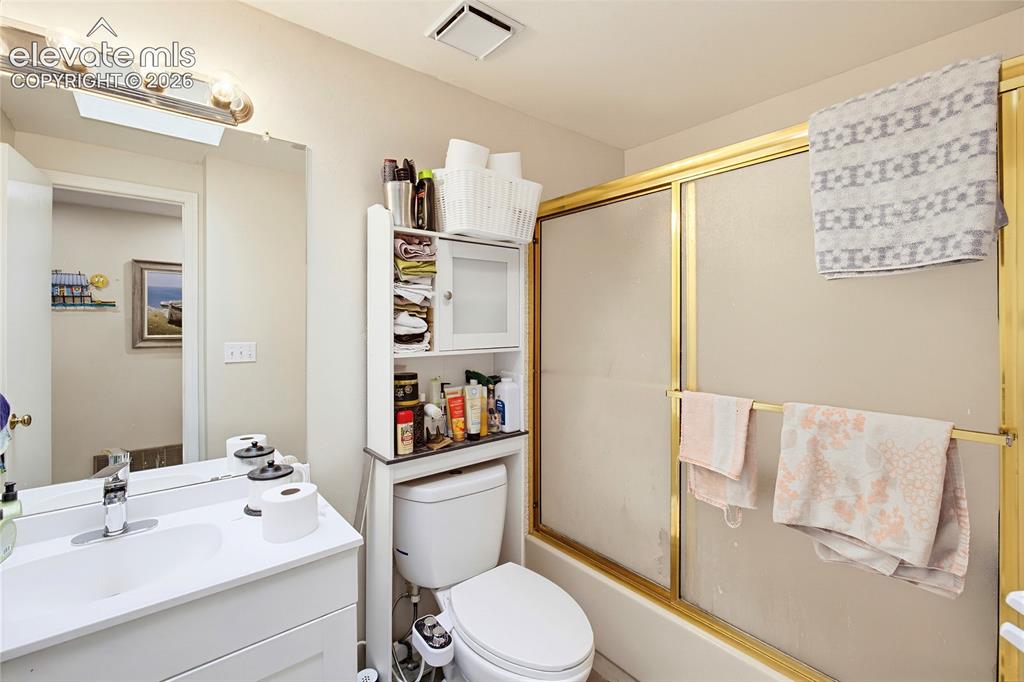 Image 24 of 32: White vanity with an integrated sink and chrome faucet