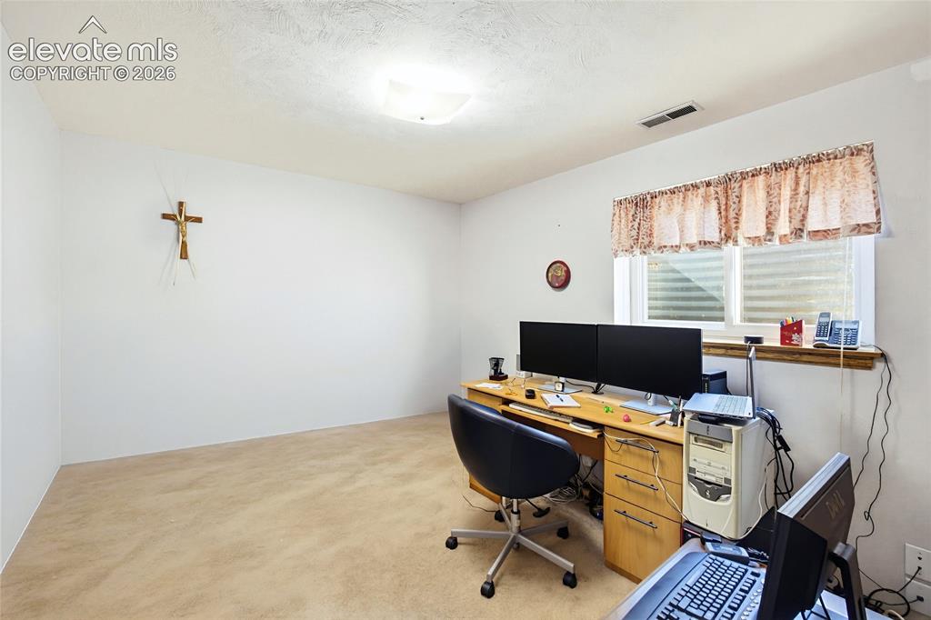 Image 28 of 31: Carpeted flooring, white walls, and a window with a wood sill
