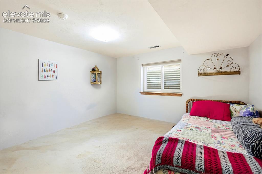 Image 29 of 31: Recessed window with white blinds and wood trim