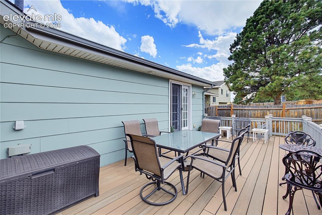 Image 6 of 32: Expansive outdoor deck with composite decking, white exterior trim, and a p