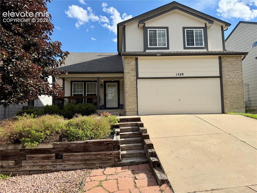 Image 1 of 50: Two-story residence featuring a two-car garage, brick facade accents, and a