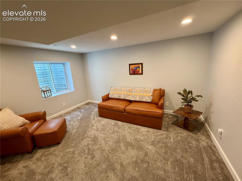 Image 28 of 50: Carpeted basement room featuring recessed lighting, a window with horizonta