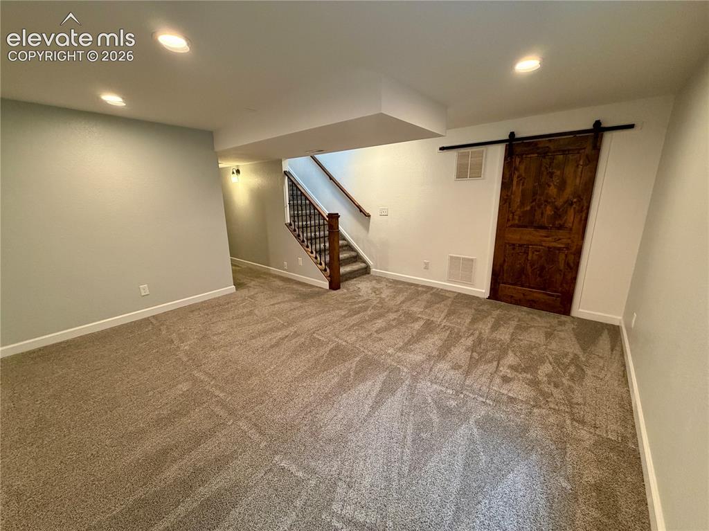 Image 29 of 50: Spacious basement room (furniture removed) featuring neutral carpeting and