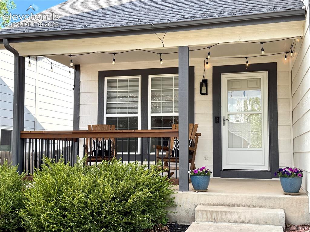 Image 3 of 50: Front covered porch featuring , white siding, and dark trim