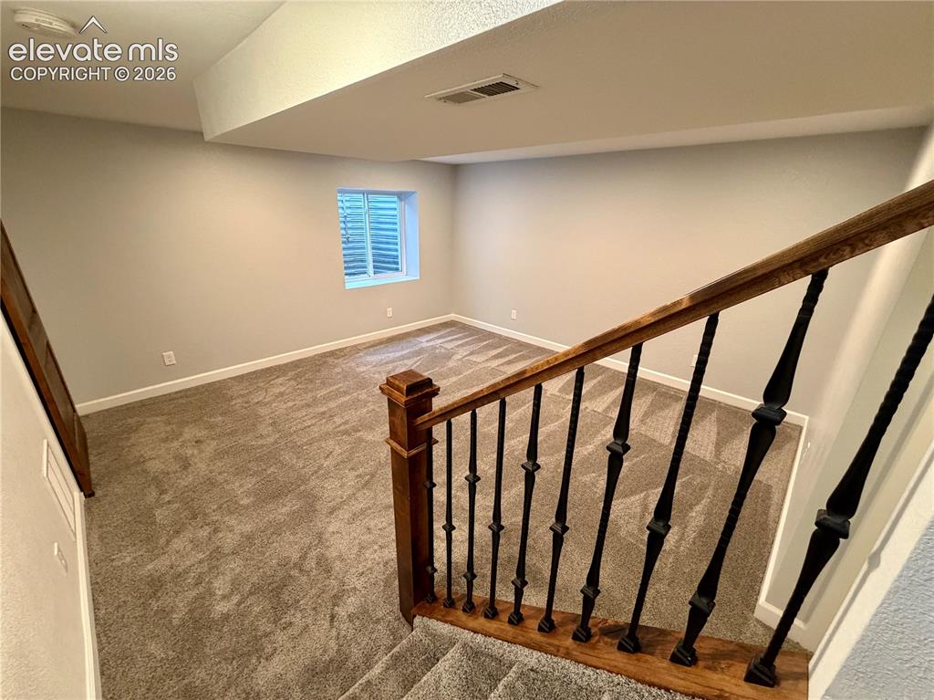 Image 30 of 50: Furniture removed-Finished lower level featuring neutral carpeting, light g