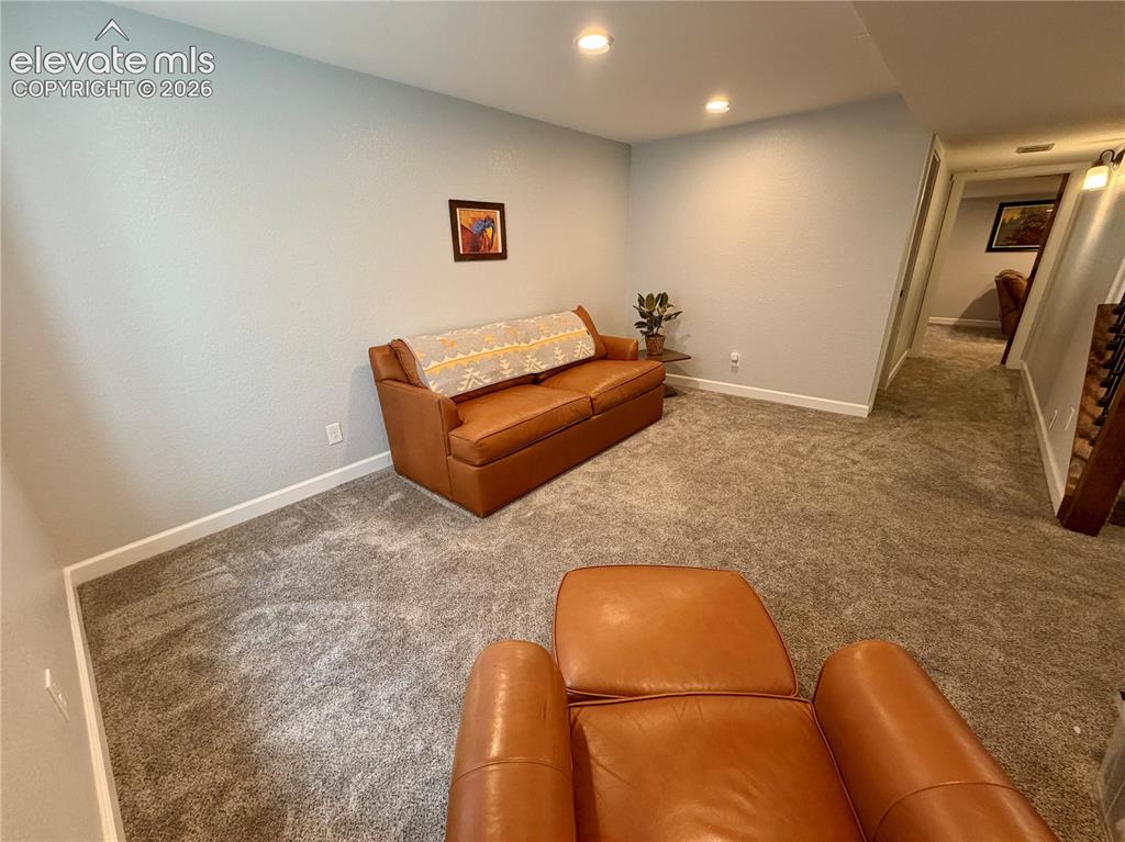 Image 31 of 50: Carpeted basement room featuring recessed lighting and white baseboards