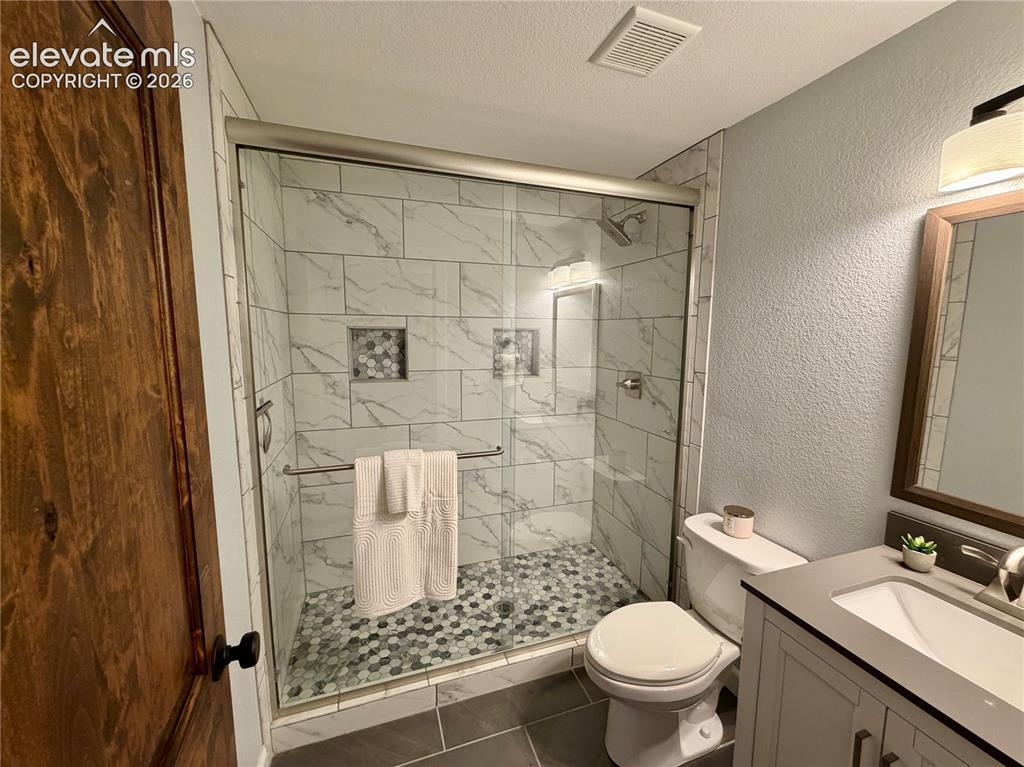 Image 32 of 50: Basement Bathroom-Contemporary bathroom featuring a walk-in shower with gla