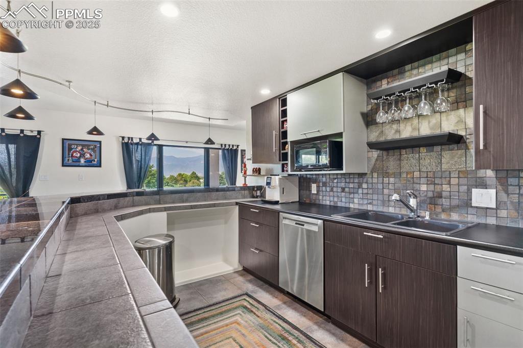 Image 34 of 44: Wet bar.  Full sized bosch dishwasher,  Mircowave, Full sized refridgerator