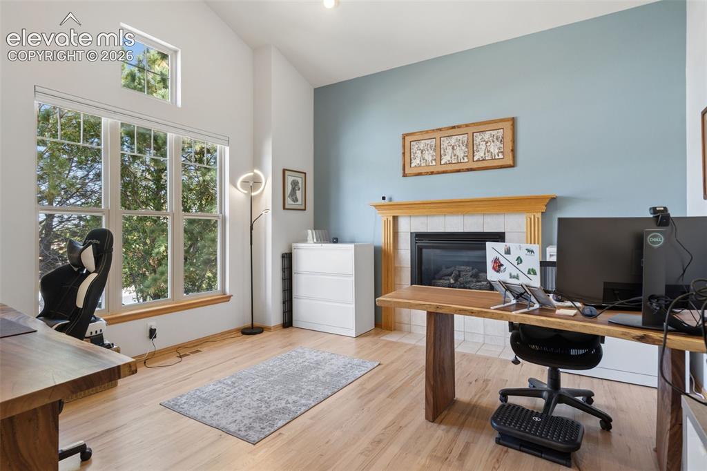 Image 3 of 50: Vaulted ceilings, expansive multi-pane windows, wood-finish flooring, and a