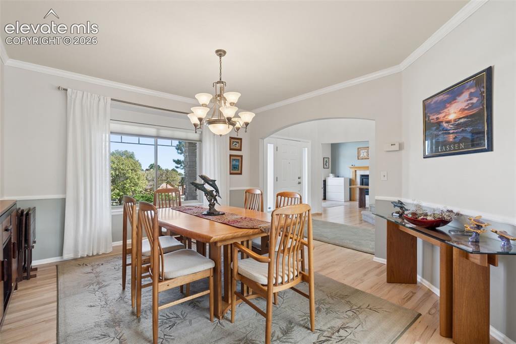 Image 4 of 50: Dining area featuring wood-finish flooring, a multi-light chandelier, chair