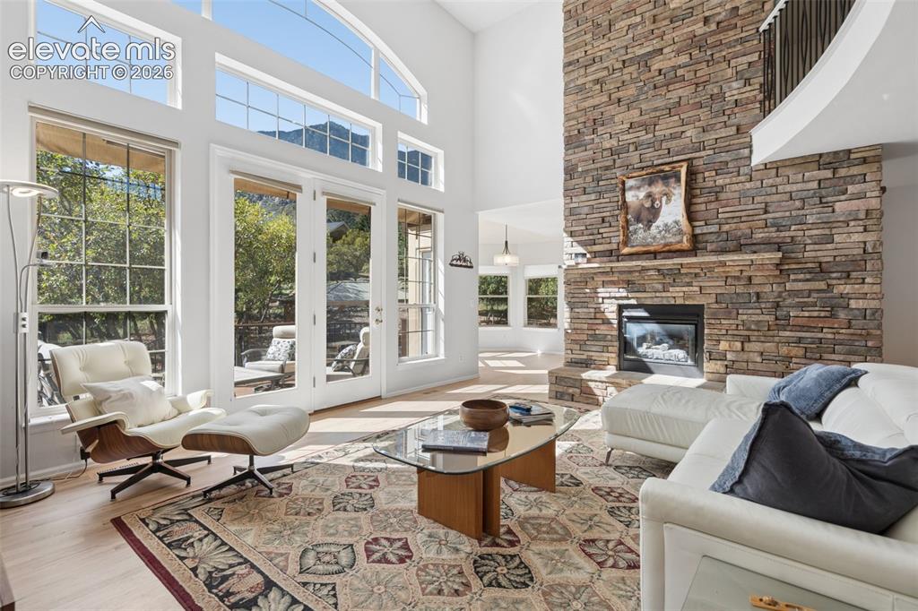 Image 7 of 50: Floor-to-ceiling stone fireplace, expansive vaulted ceilings, large multi-p
