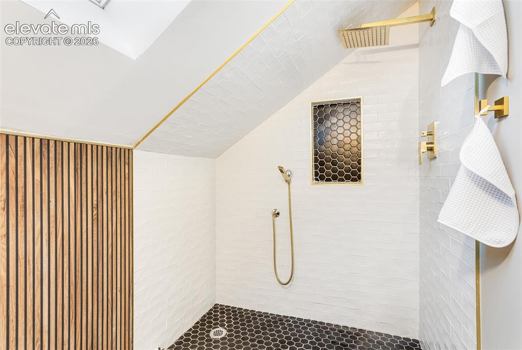 Image 23 of 43: Built-in shower featuring a rain shower head, handheld shower fixture, and