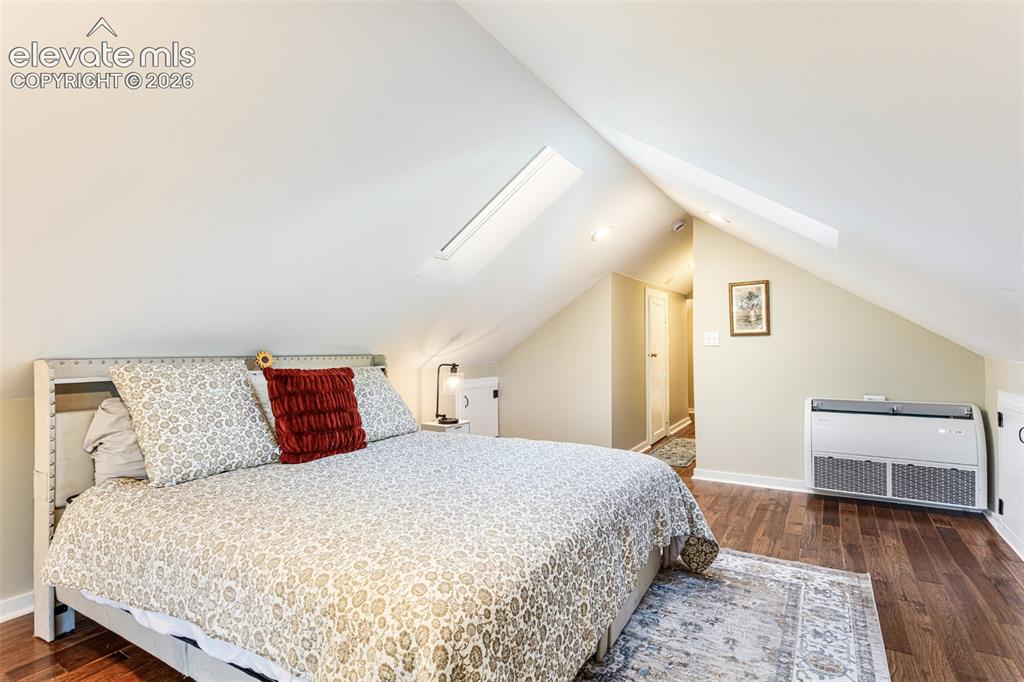 Image 25 of 43: Room with sloped ceilings featuring two skylights, recessed lighting, and w