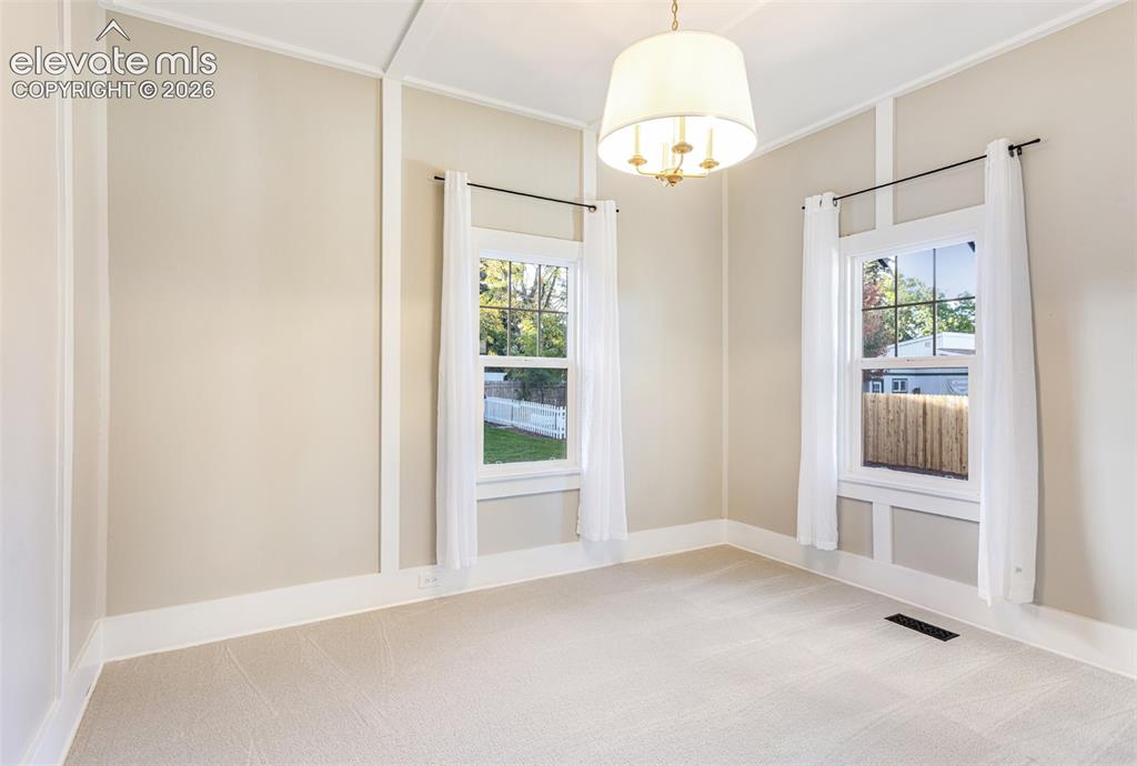 Image 30 of 43: Carpeted room featuring a ceiling-mounted drum pendant light fixture