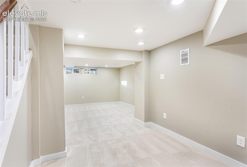 Image 33 of 43: Finished lower level featuring recessed lighting, light-toned carpeting, an