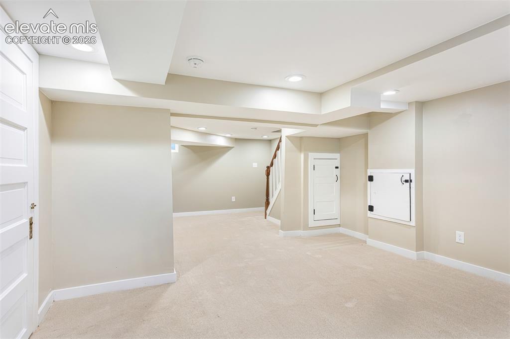 Image 34 of 43: Spacious carpeted room featuring recessed lighting, painted walls, white tr