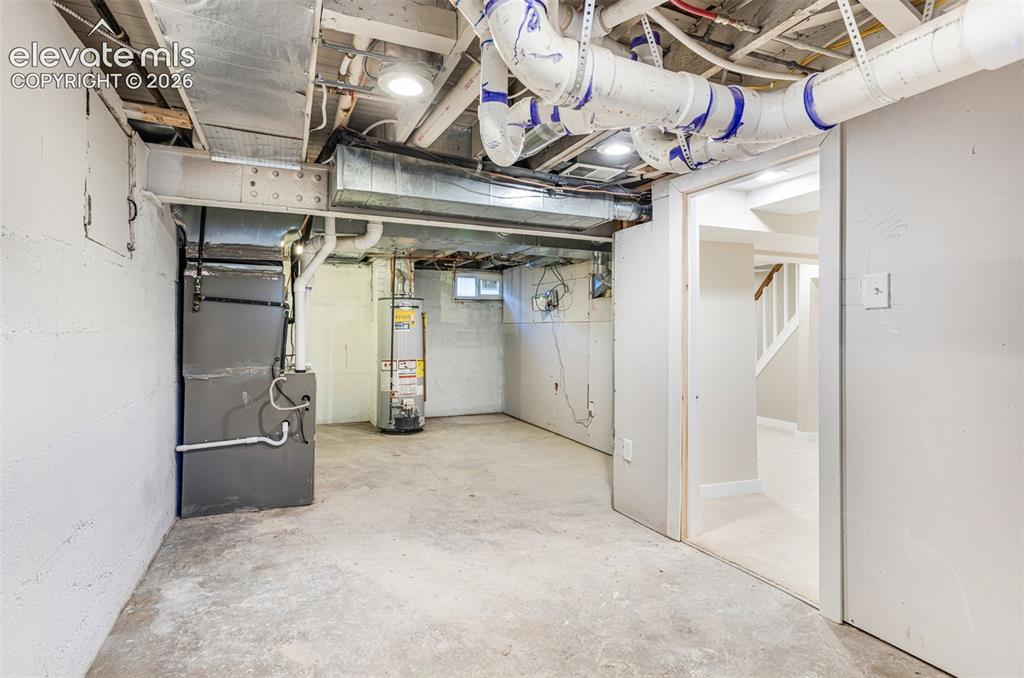 Image 40 of 43: Unfinished basement space with concrete flooring