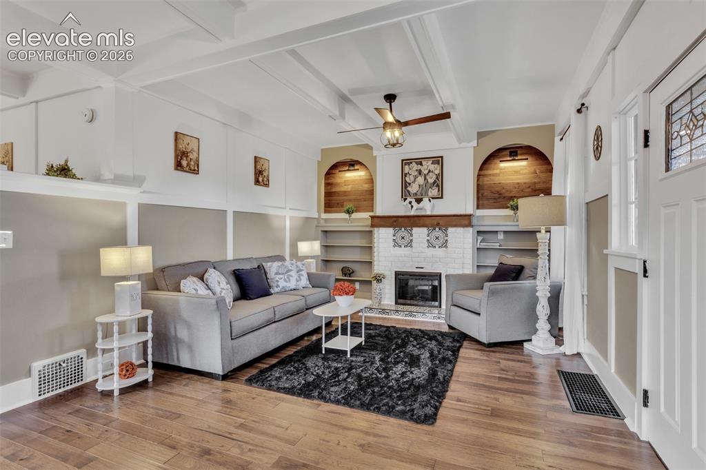 Image 5 of 43: Living room featuring wood-finish flooring, white coffered ceilings, and a