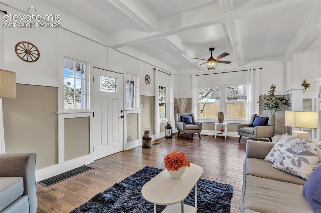 Image 6 of 43: Living area featuring wood-finish flooring, a coffered ceiling, and a ceili