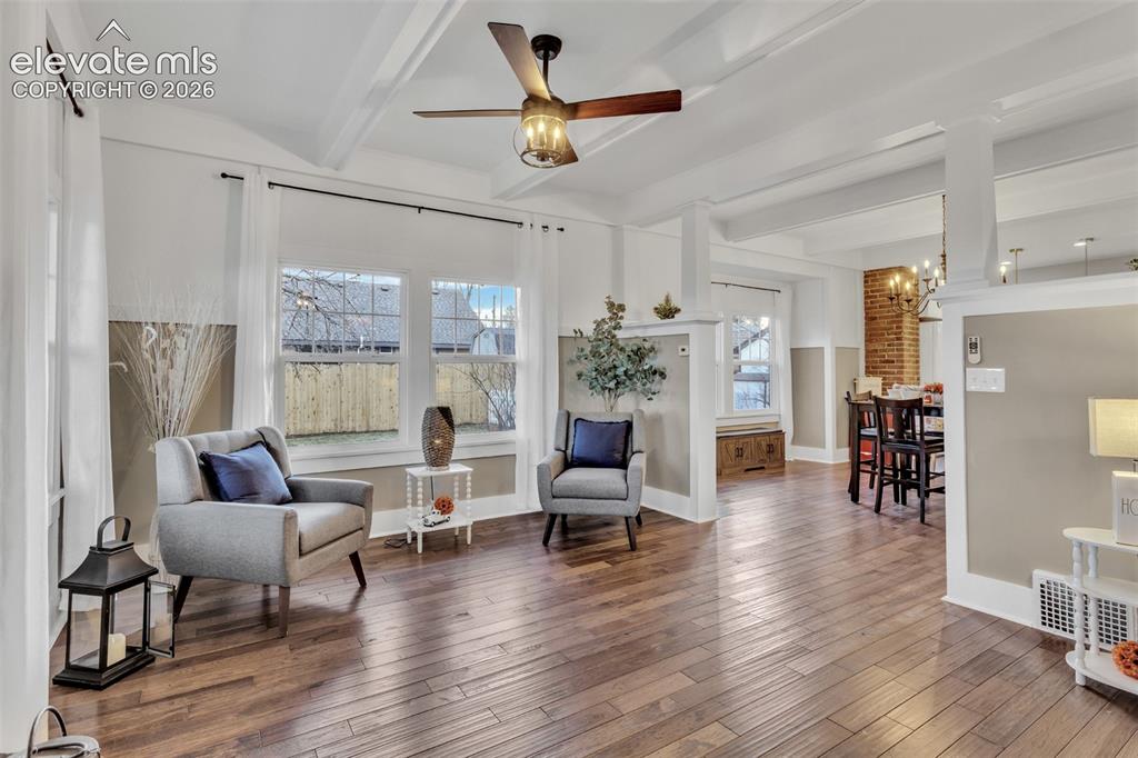 Image 7 of 43: Open-concept living space featuring wood-finish flooring, white coffered ce