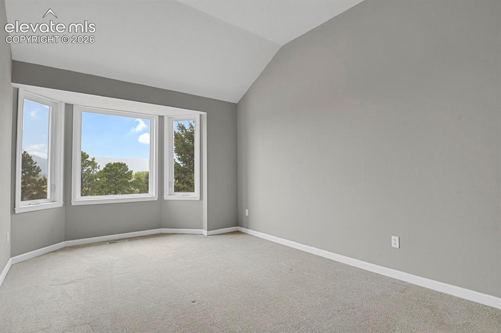 Image 18 of 35: Sunny & bright with a vaulted ceiling