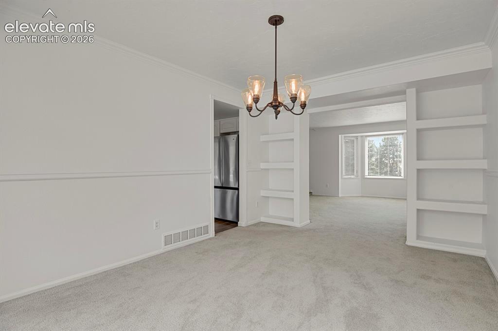 Image 7 of 35: Built-ins for decor, dishes, or photos