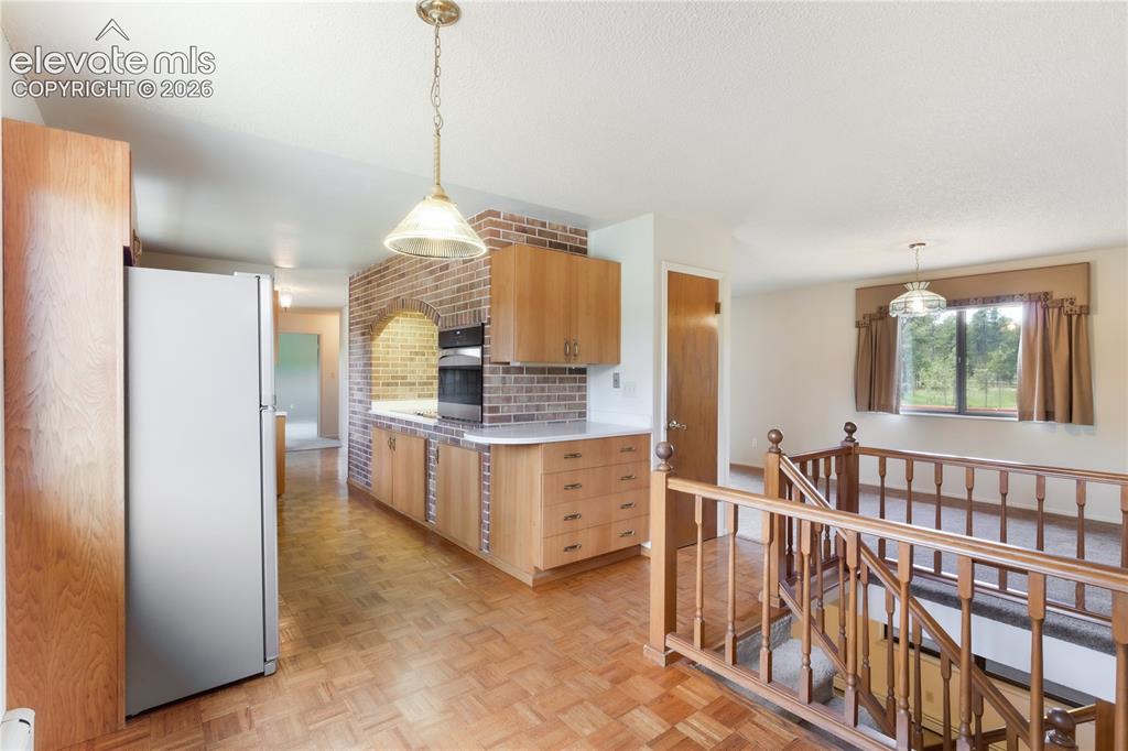 Image 15 of 47: Kitchen, looking toward the entryway